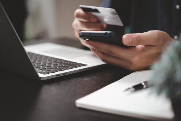 person with credit card shopping online