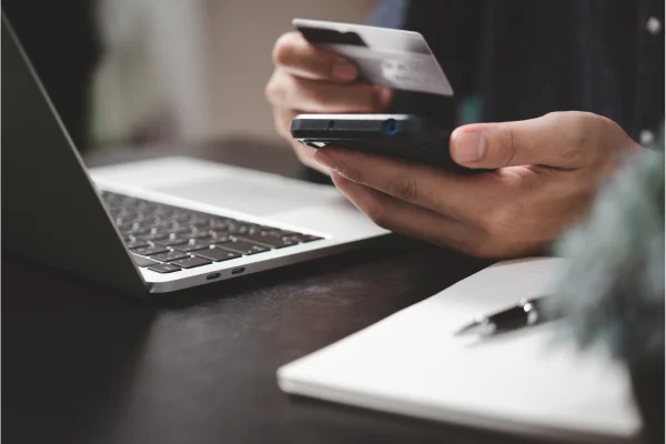 person with credit card shopping online